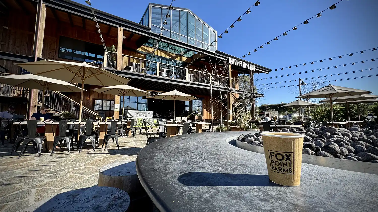 A cup of coffee sits on the patio fire ring at Fox Point Farms in Encinitas, California